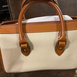 Cream Dooney & Burke bag with brown trim.